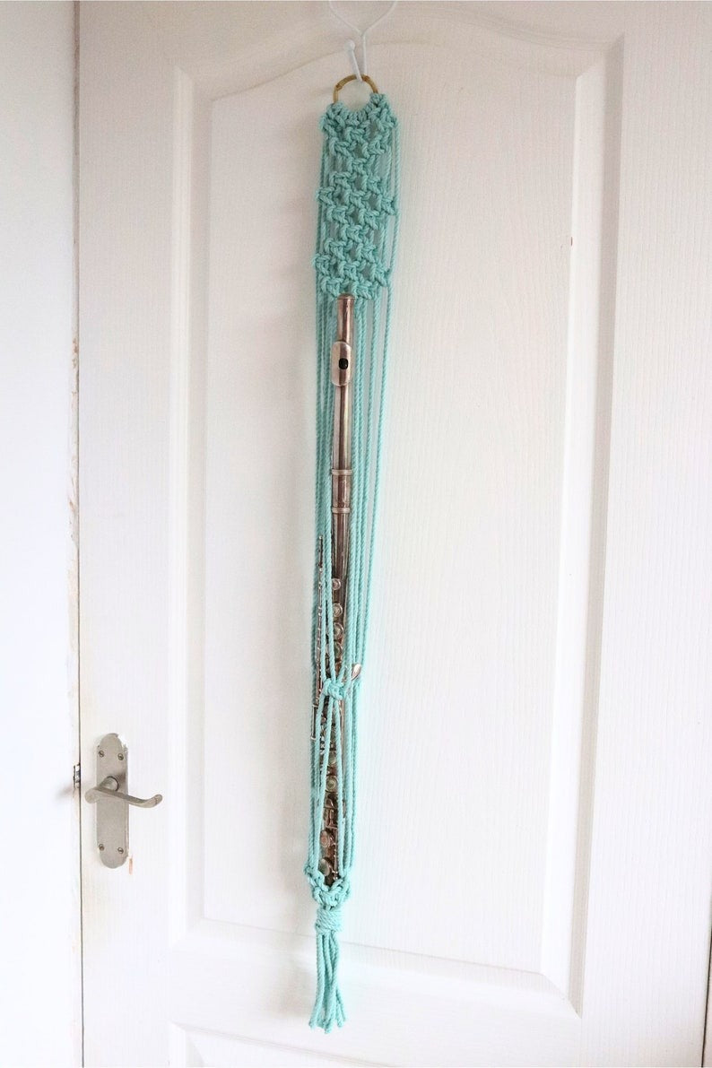 Turquoise hammock hanging on a white door